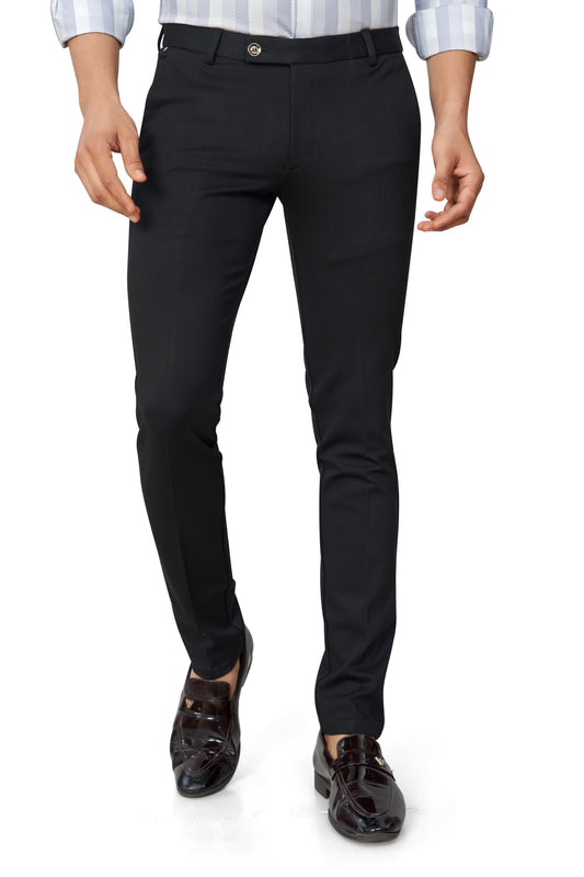 Person wearing black pants and a white shirt on a white background